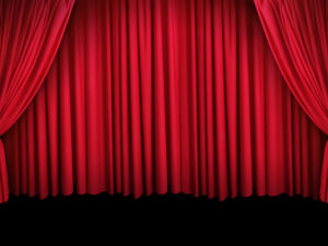 Image of a large stage with a red theatre curtain